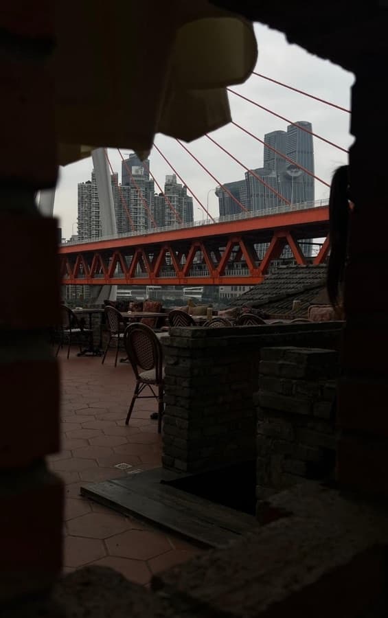 Darerca Chaw — A rooftop framing the river bridge