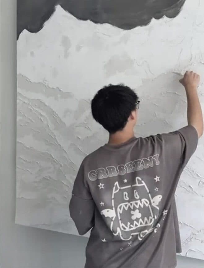 Hong Li — Working on a textured wall mural